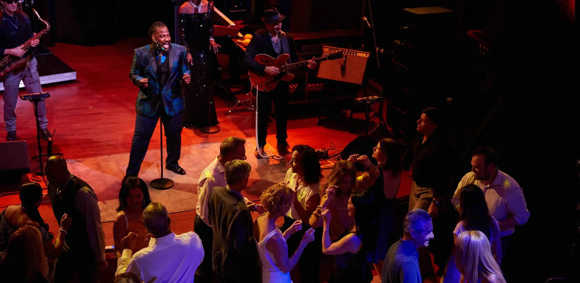 Live jazz performance with singer and band, audience enjoying intimate concert