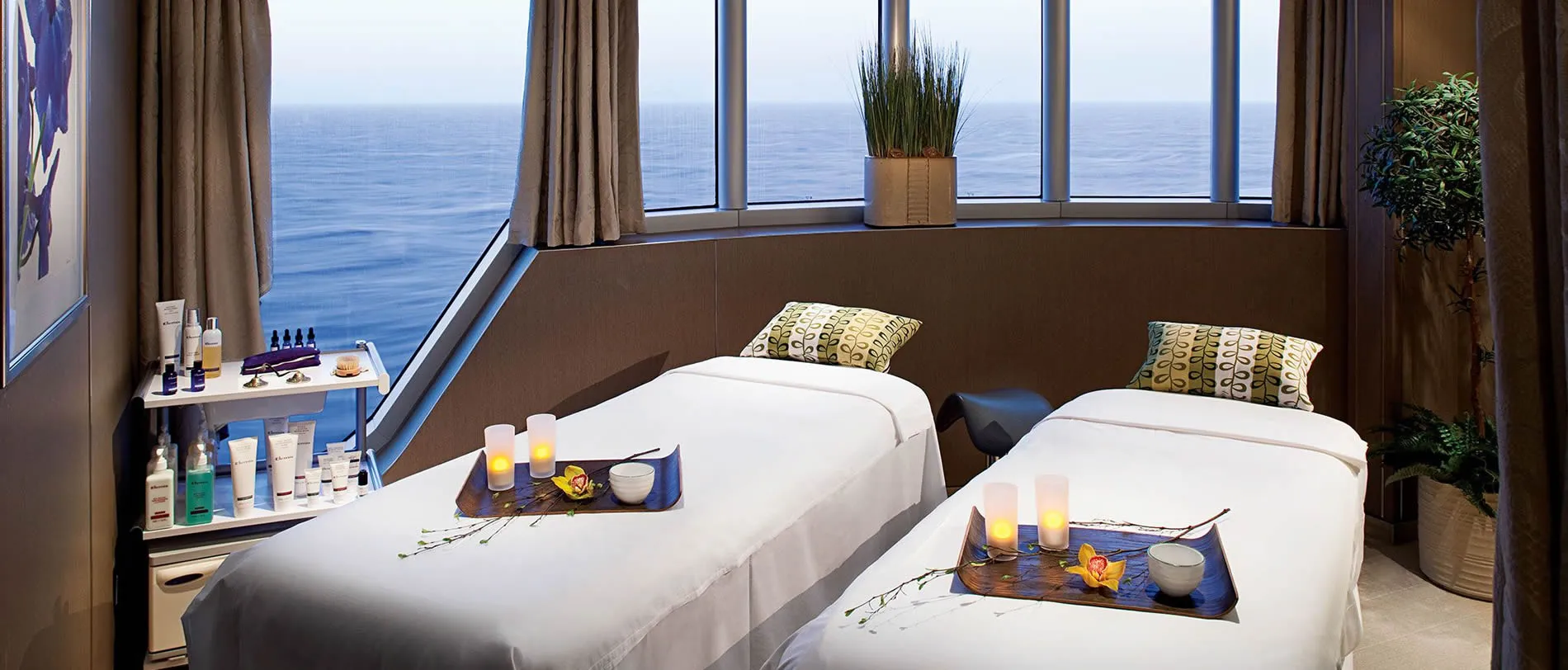Spa room with two massage beds overlooking serene ocean view