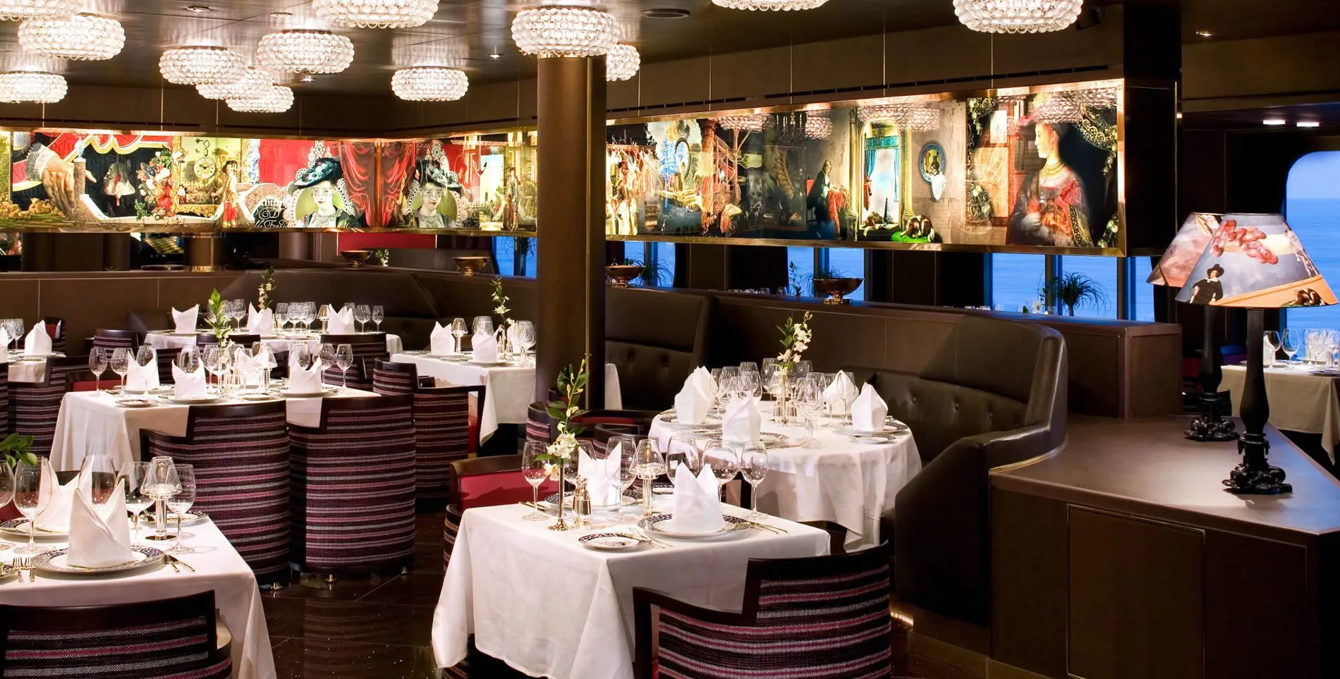 Elegant restaurant interior with crystal chandeliers and artistic wall decorations