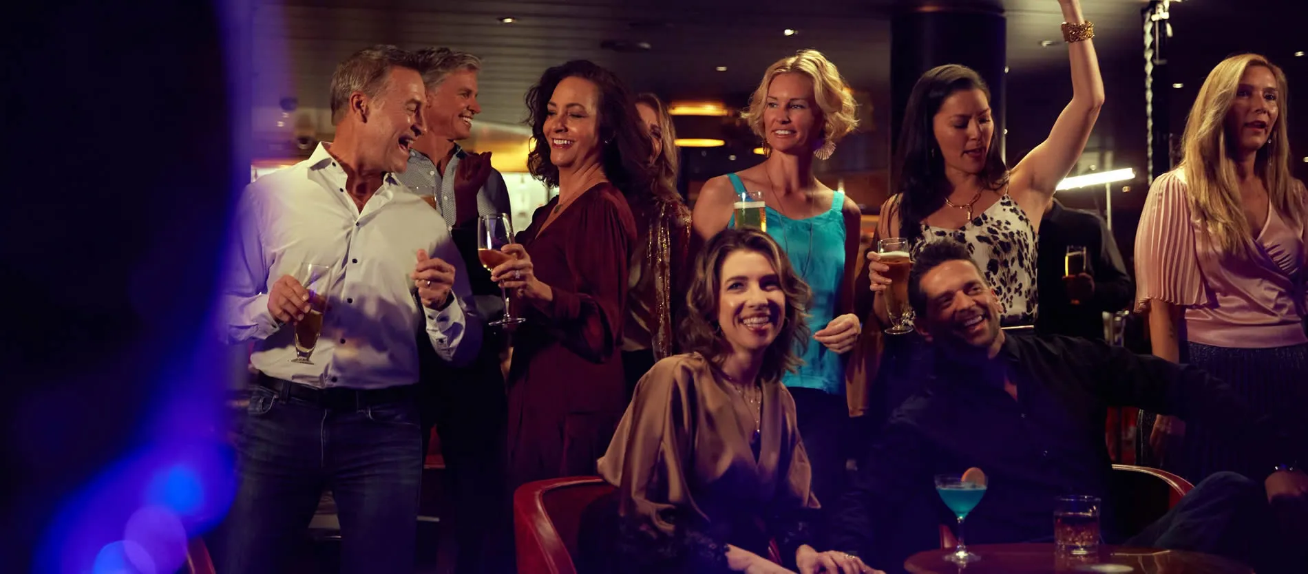 Diverse group of friends enjoying drinks and socializing at a bar