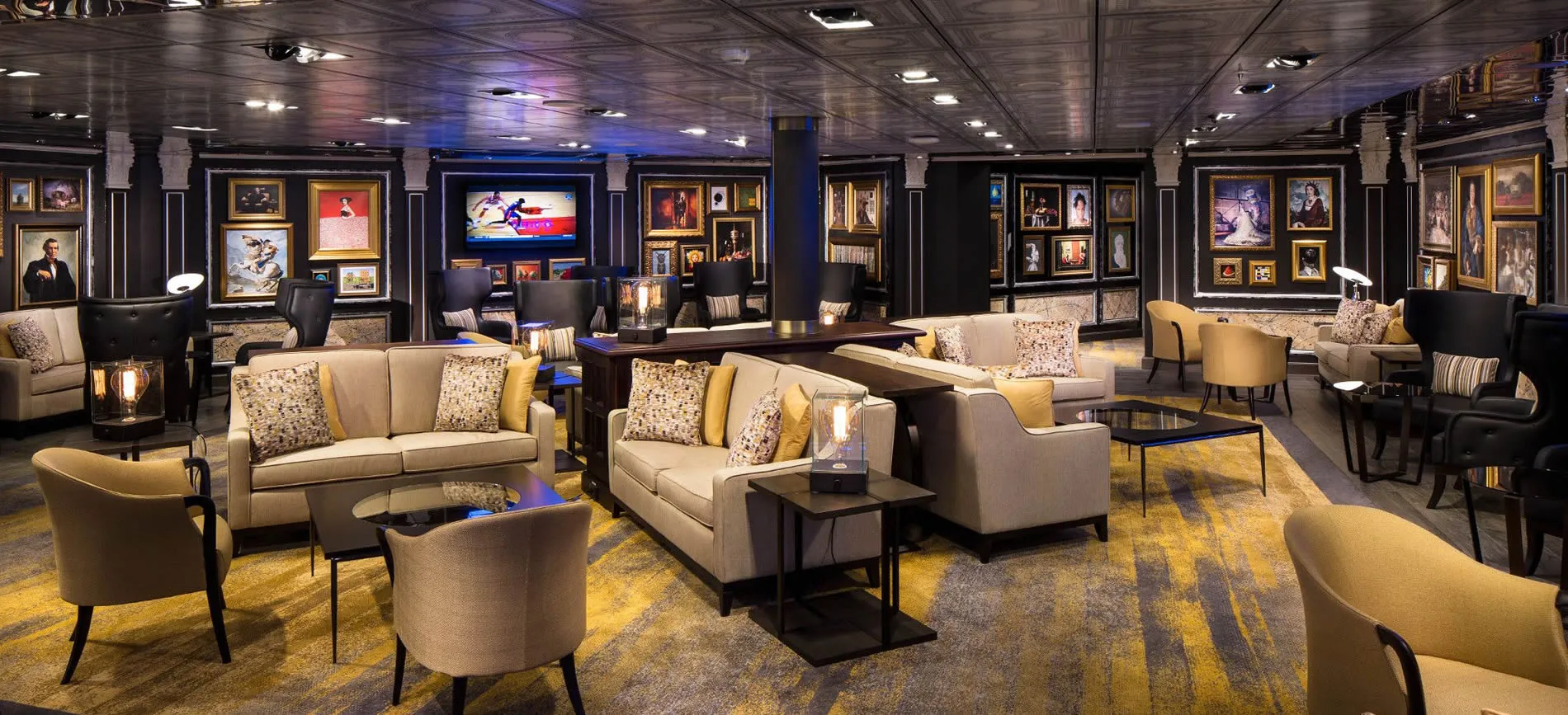 Elegant lounge with art gallery walls, comfortable seating, and warm lighting