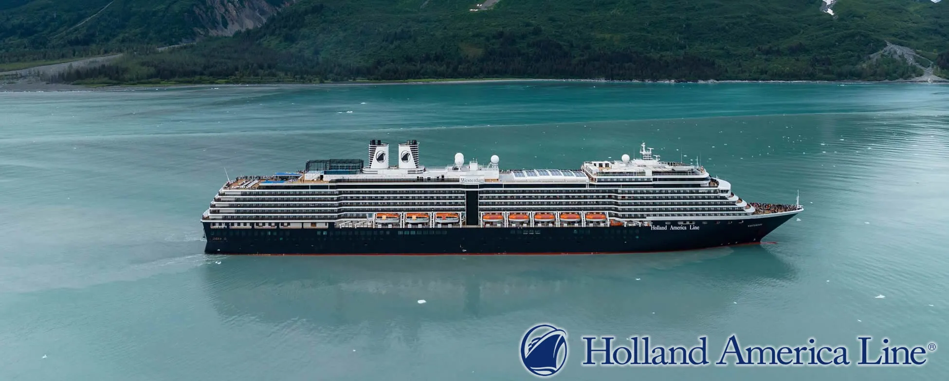 Holland America cruise ship sailing through scenic Alaskan coastal waters