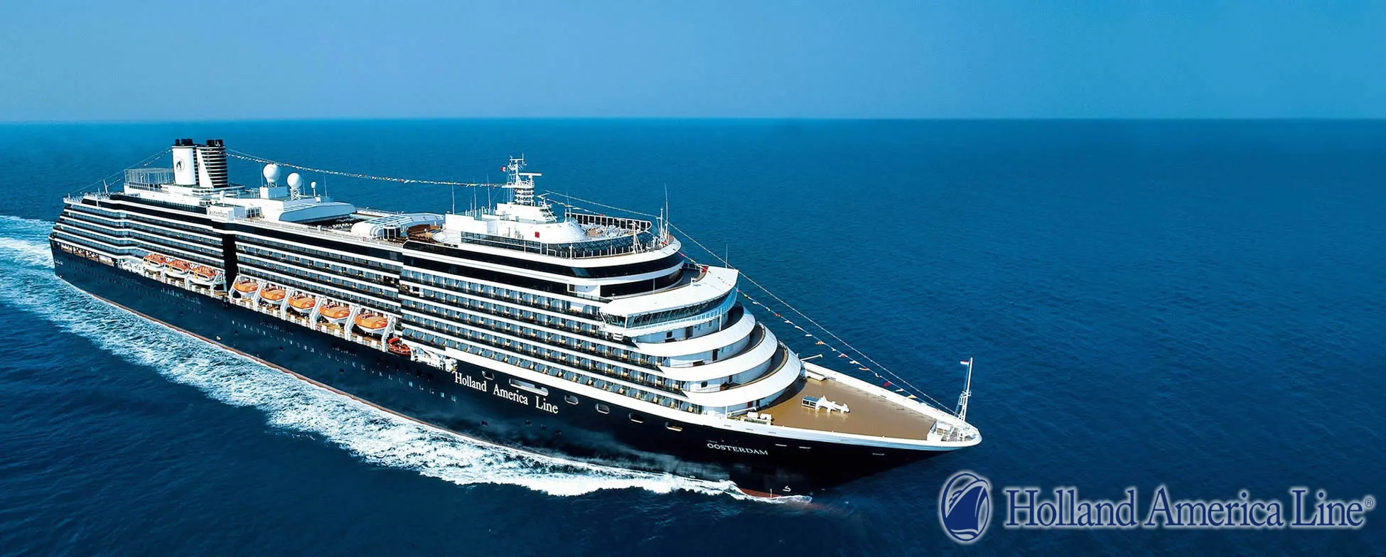 Holland America Line cruise ship sailing on blue ocean