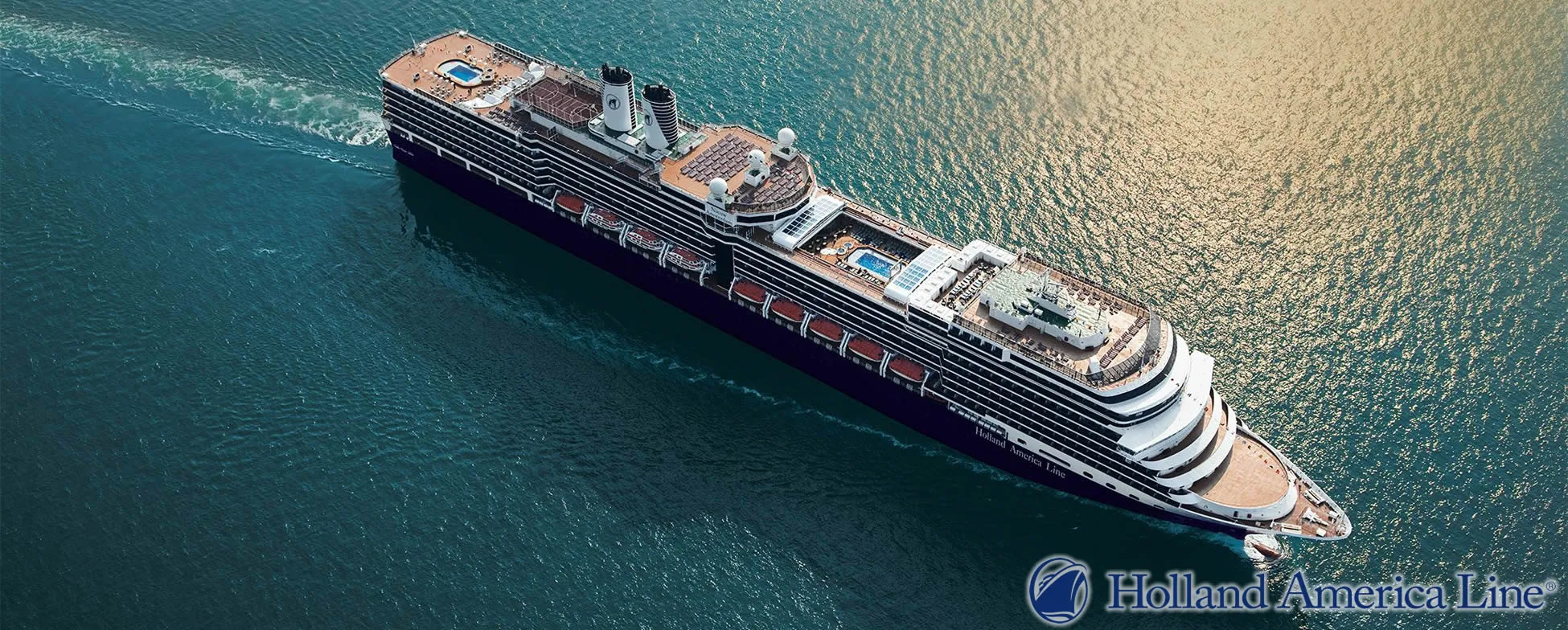 Holland America Line cruise ship sailing on blue ocean with multiple decks