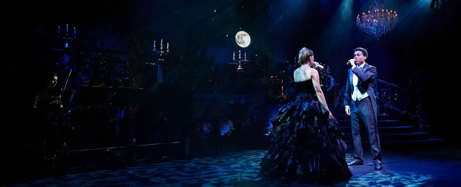 Phantom of the Opera stage scene with two performers under moonlight