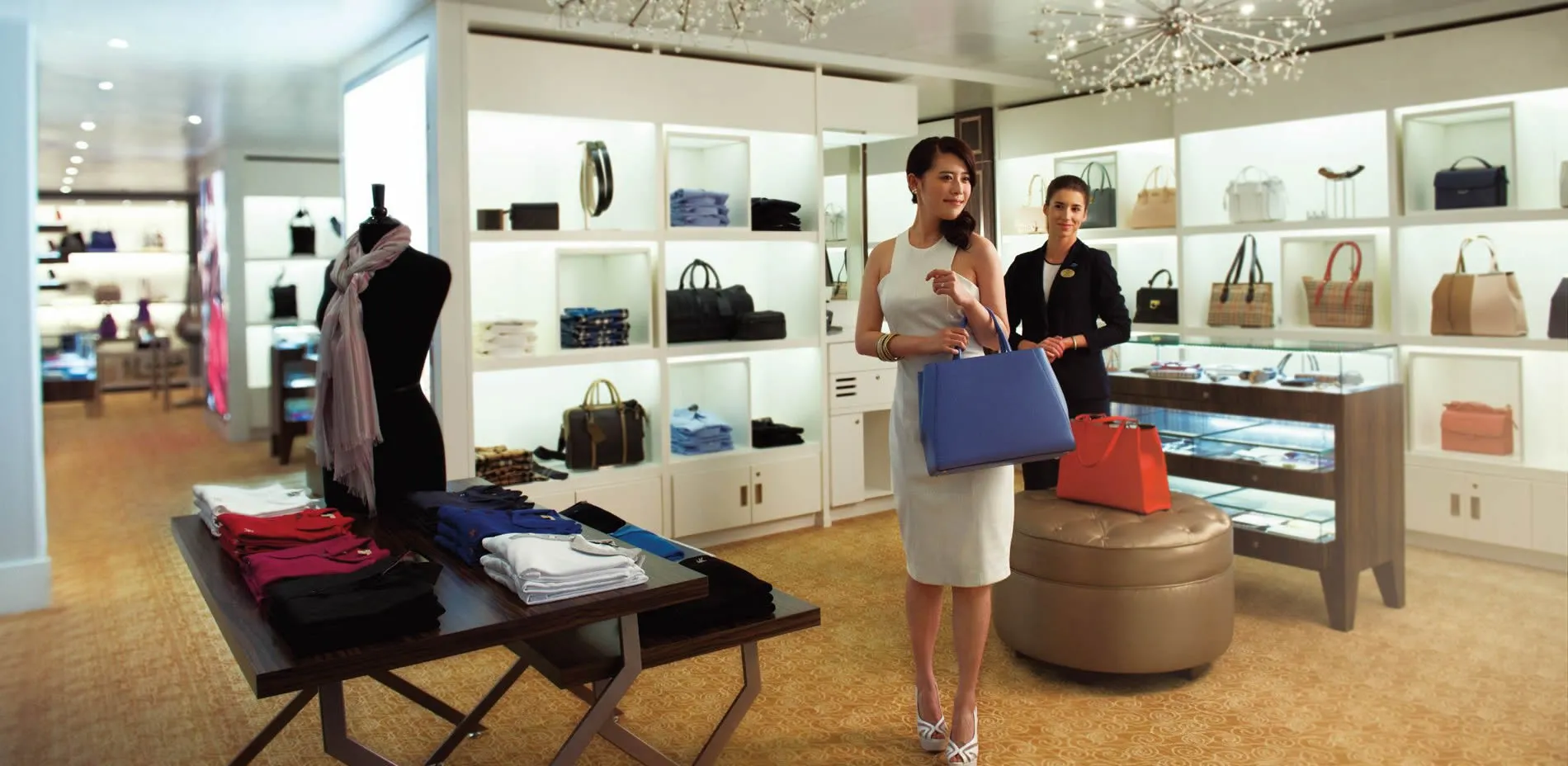 Women shopping in elegant boutique with handbags and clothing displays