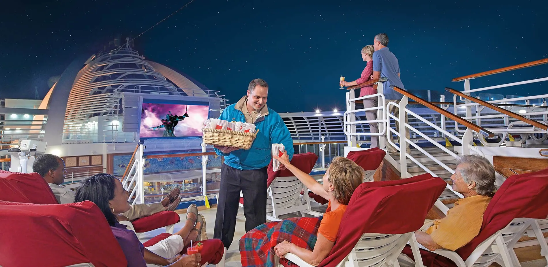 Cruise ship deck with passengers relaxing and crew member serving snacks