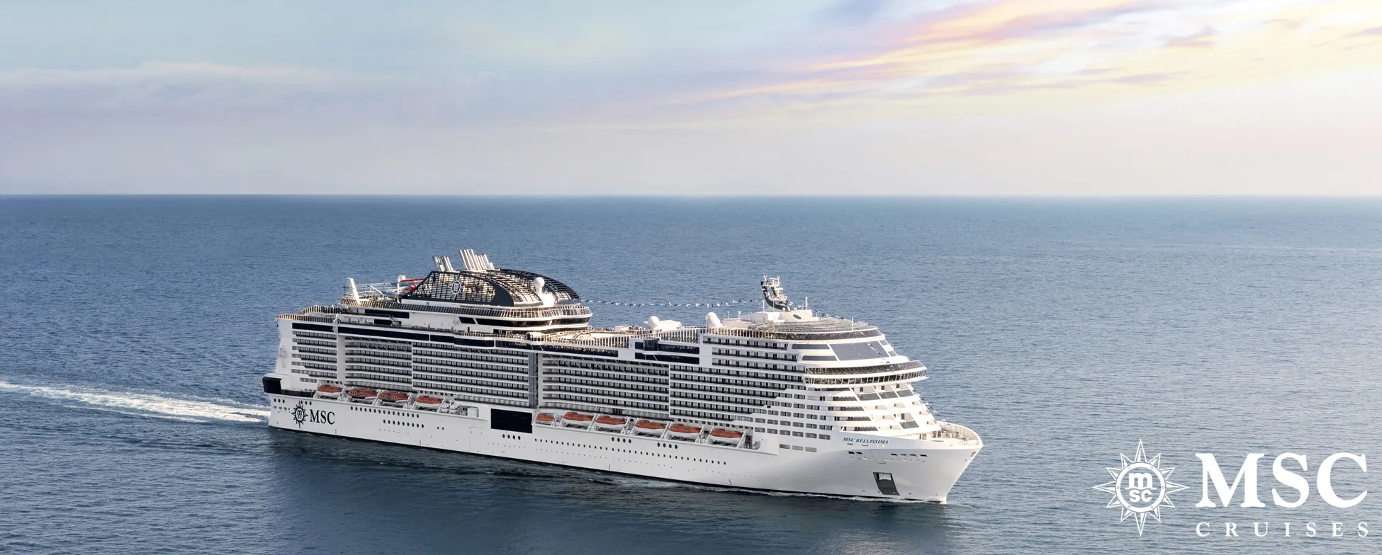 Large white MSC cruise ship sailing on calm blue ocean waters