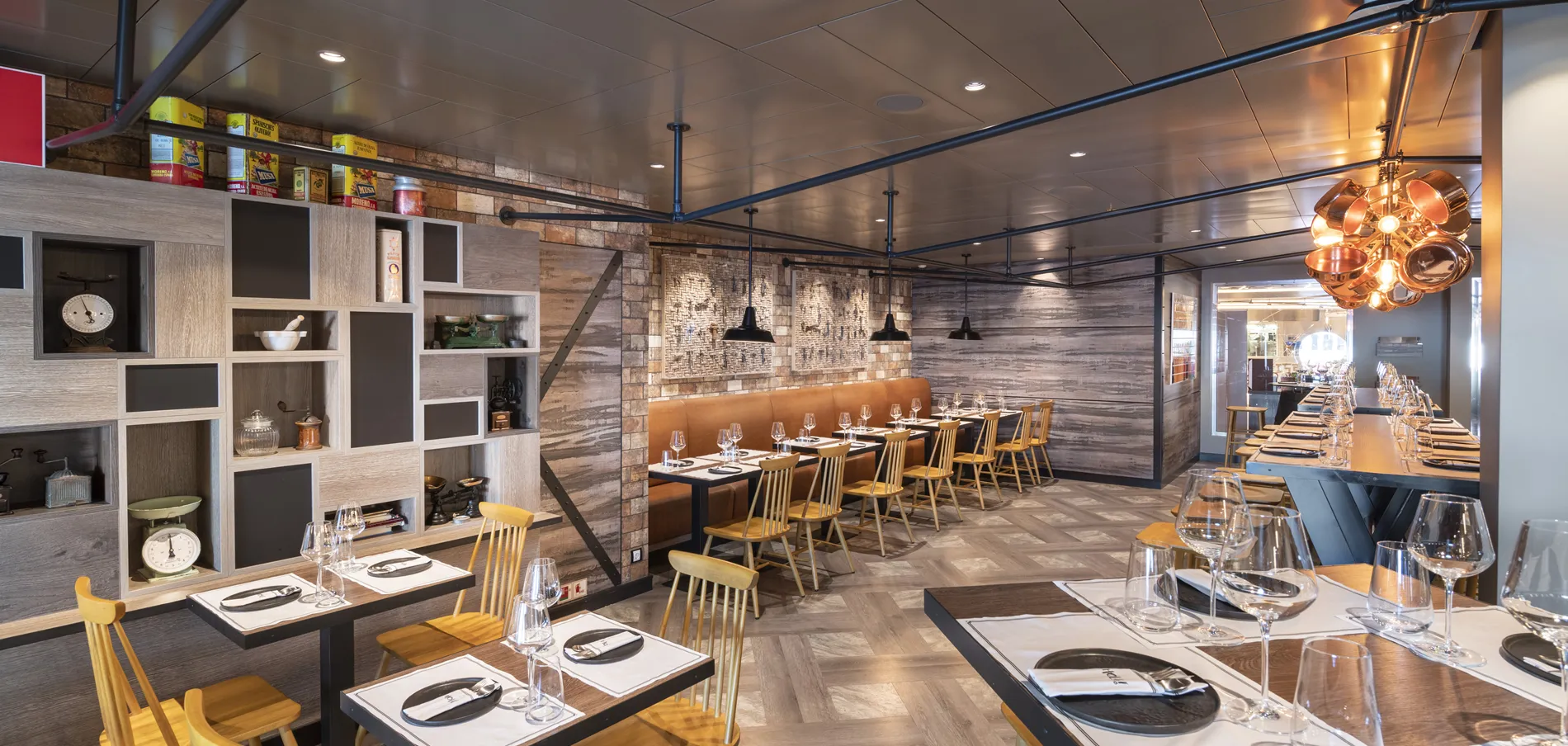 Modern restaurant interior with wooden decor, yellow chairs, and table settings