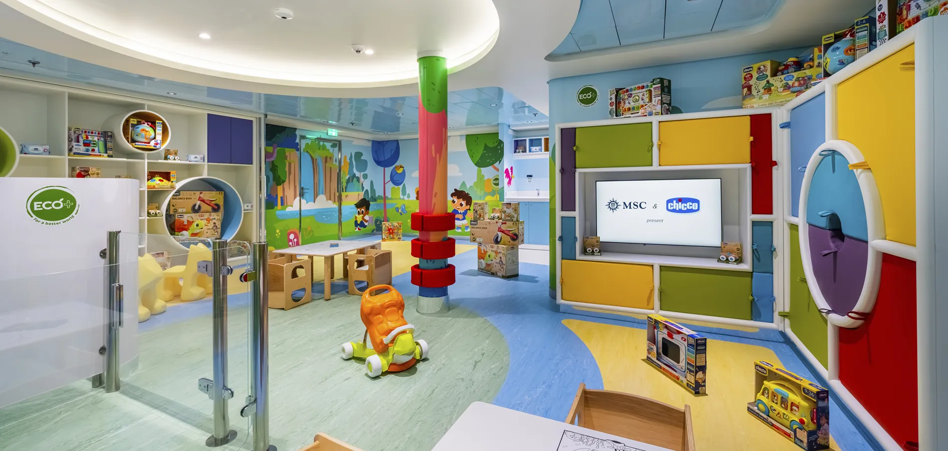 Colorful children's playroom with toys, cartoon wall mural, and wooden furniture