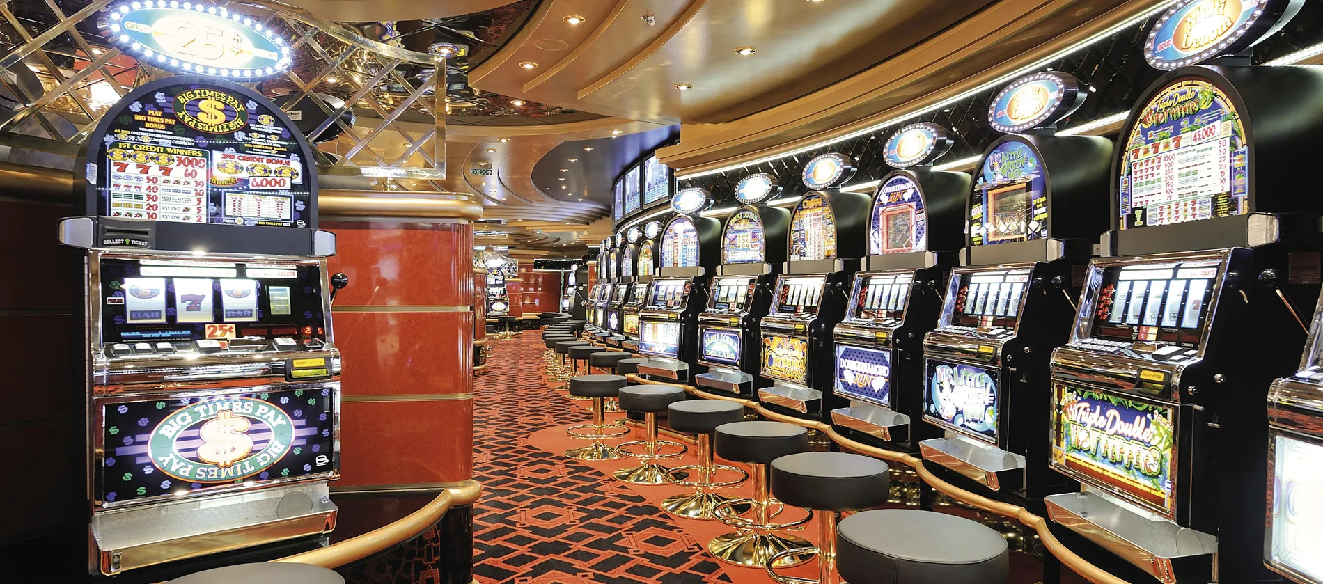 Brightly lit casino interior with rows of colorful slot machines