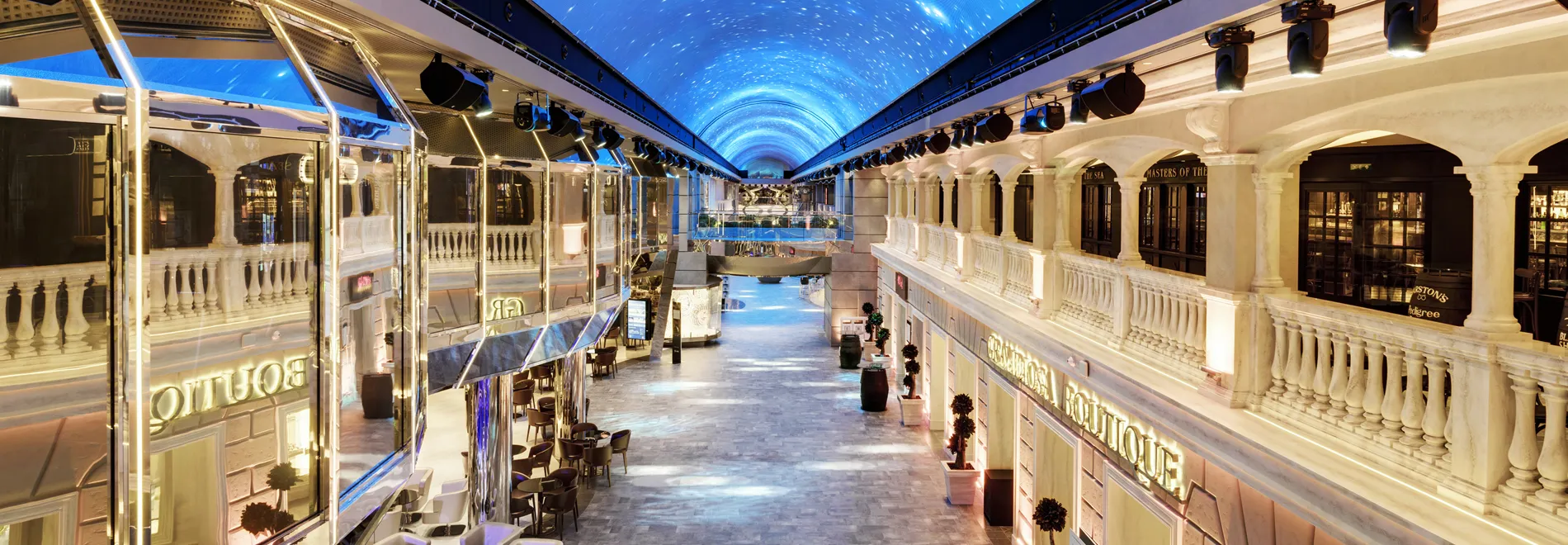 Luxurious indoor mall with starry blue ceiling and elegant white architecture
