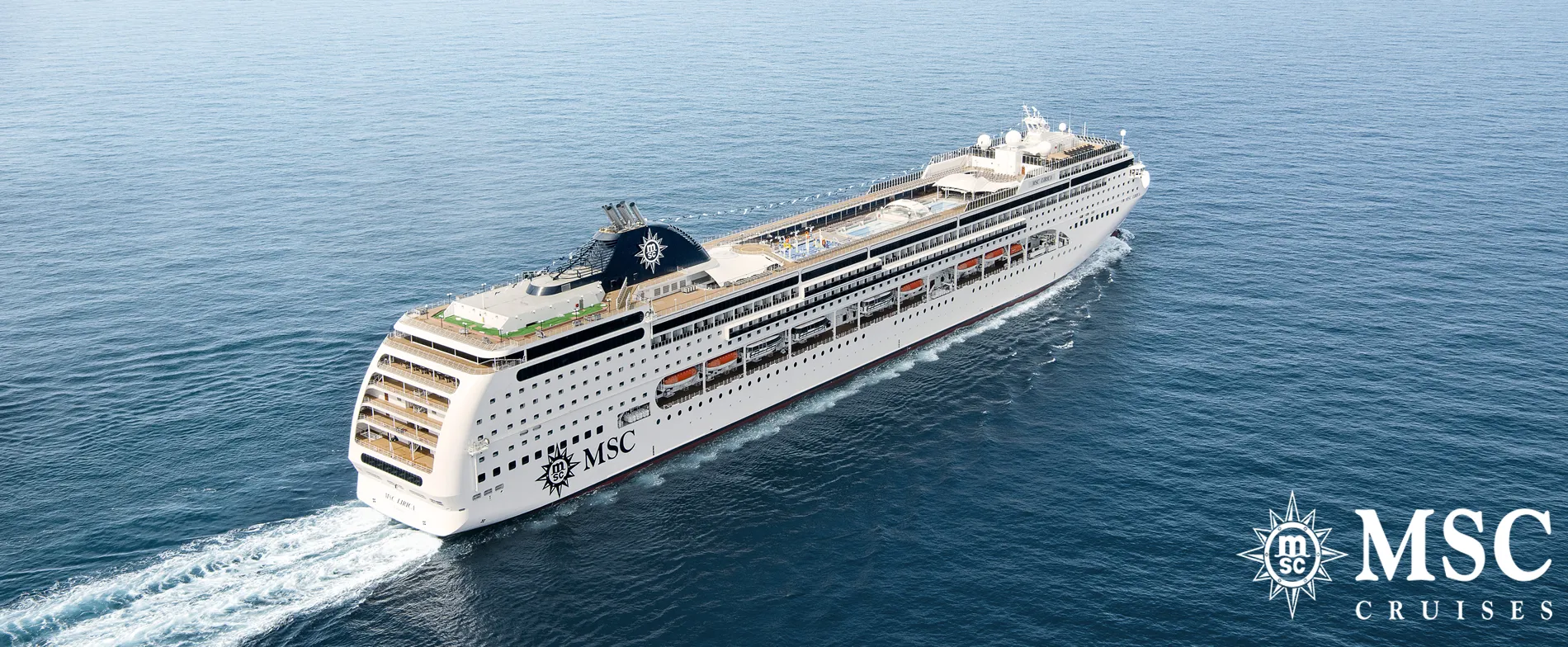 MSC cruise ship sailing on calm blue ocean with white wake