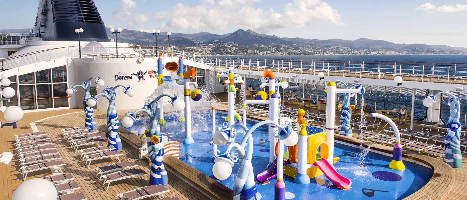 Colorful children's water park on cruise ship deck with ocean view