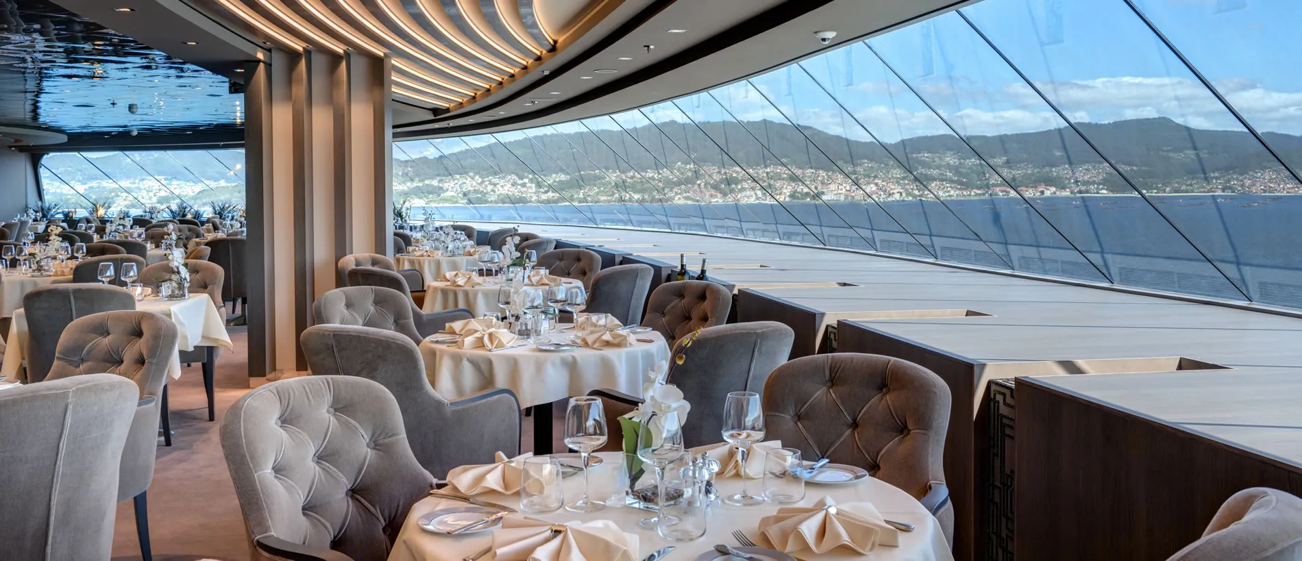Elegant dining room with panoramic ocean and mountain view