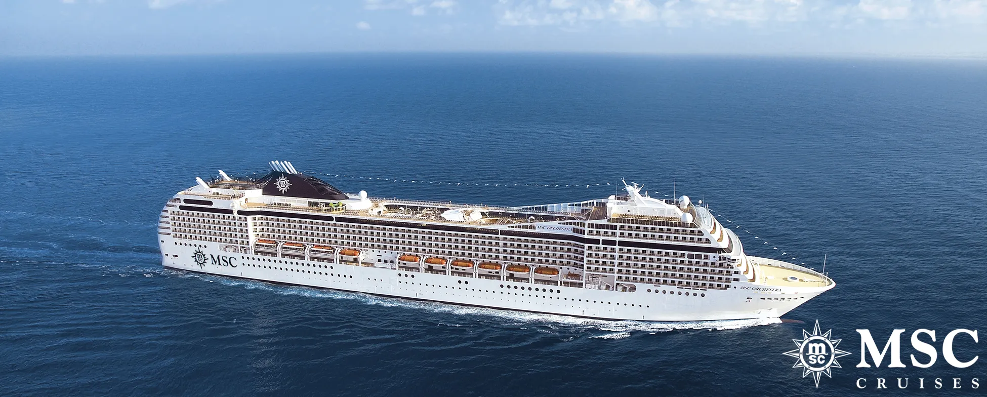 Large white MSC cruise ship sailing on blue ocean with clear sky