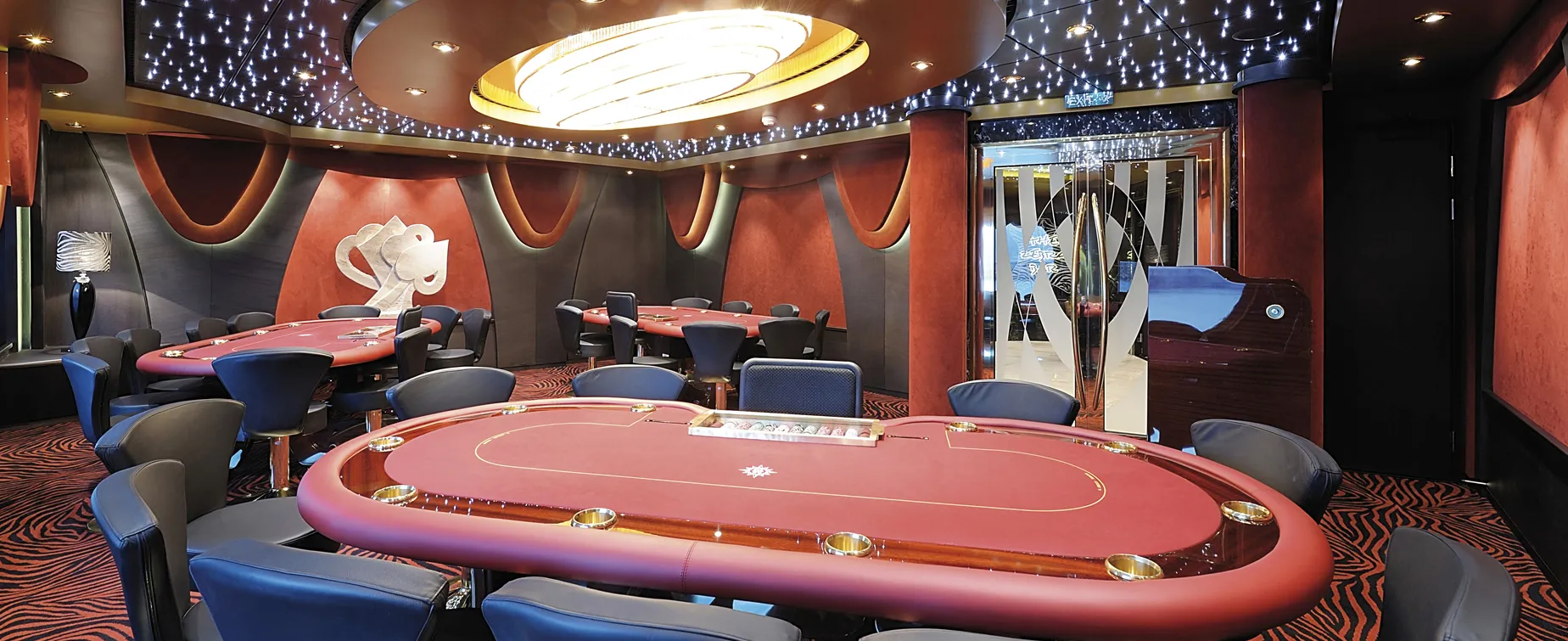Luxurious casino poker room with starry ceiling and red gaming tables