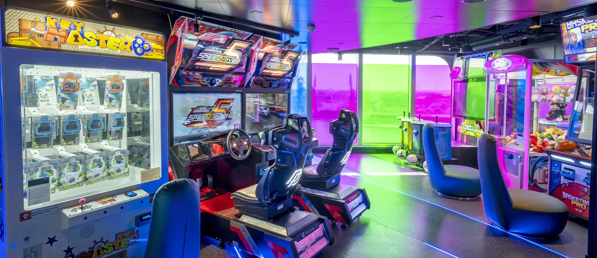 Colorful arcade with racing game simulators and claw machines