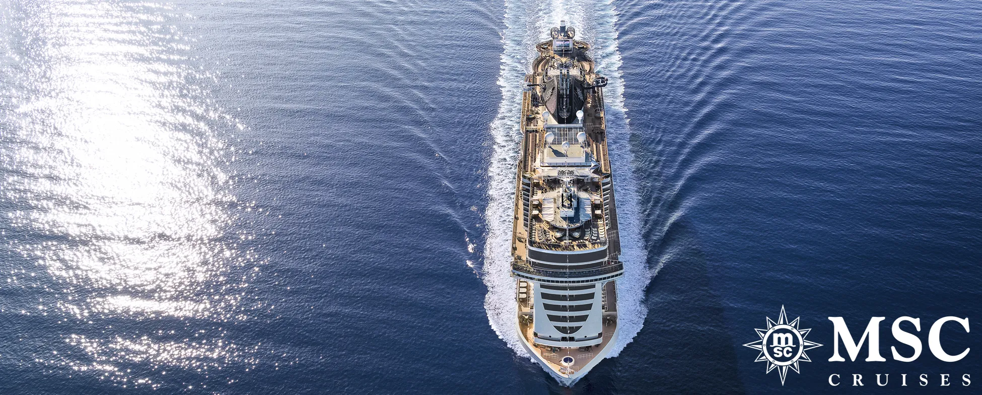 MSC cruise ship sailing on blue ocean, viewed from above