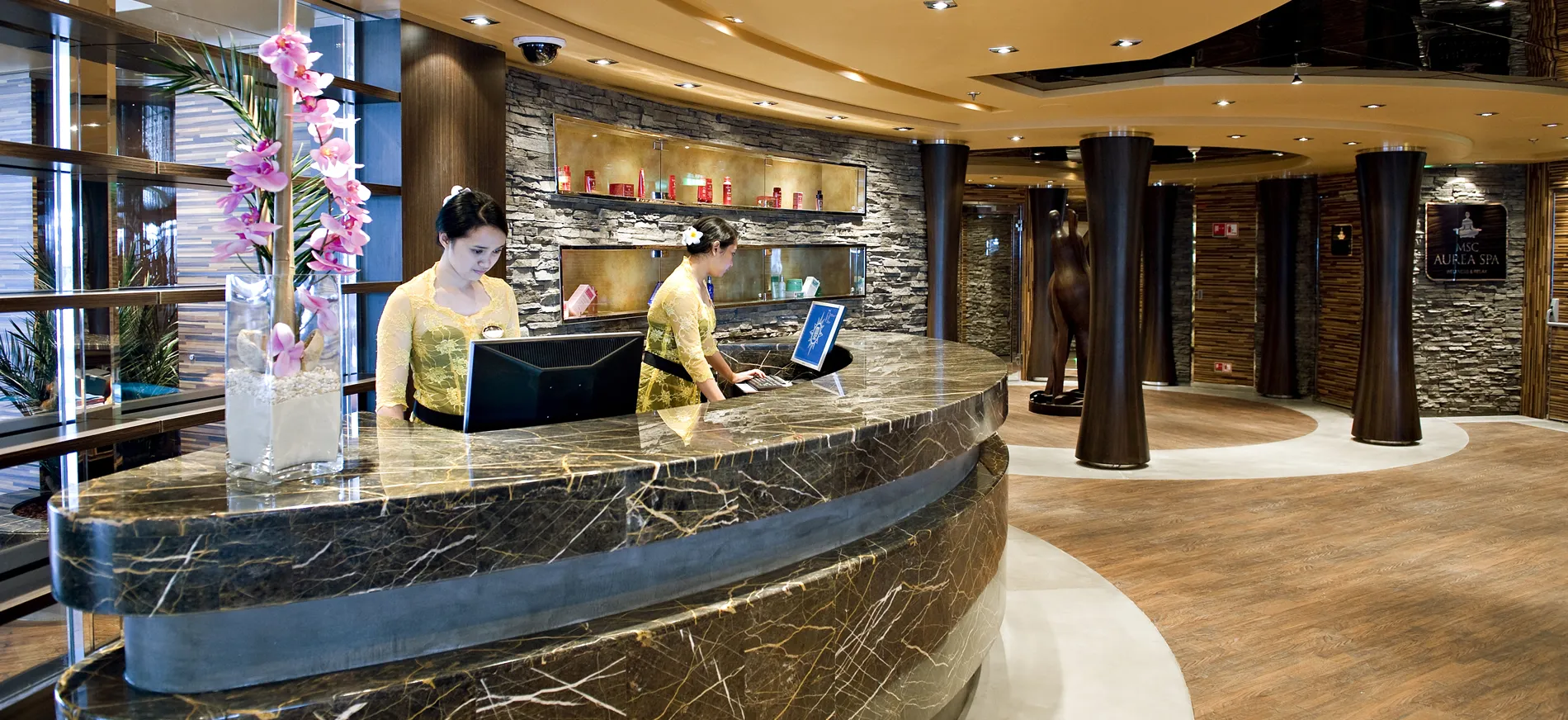 Elegant spa reception desk with marble counter and orchid decoration