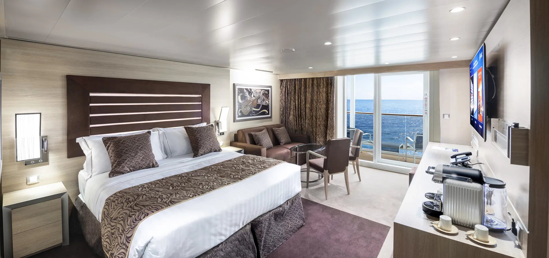 Luxurious cruise ship cabin with ocean view, modern decor, and large bed