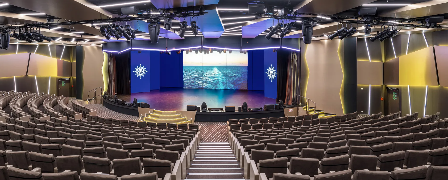 Modern auditorium with ocean backdrop and dramatic lighting