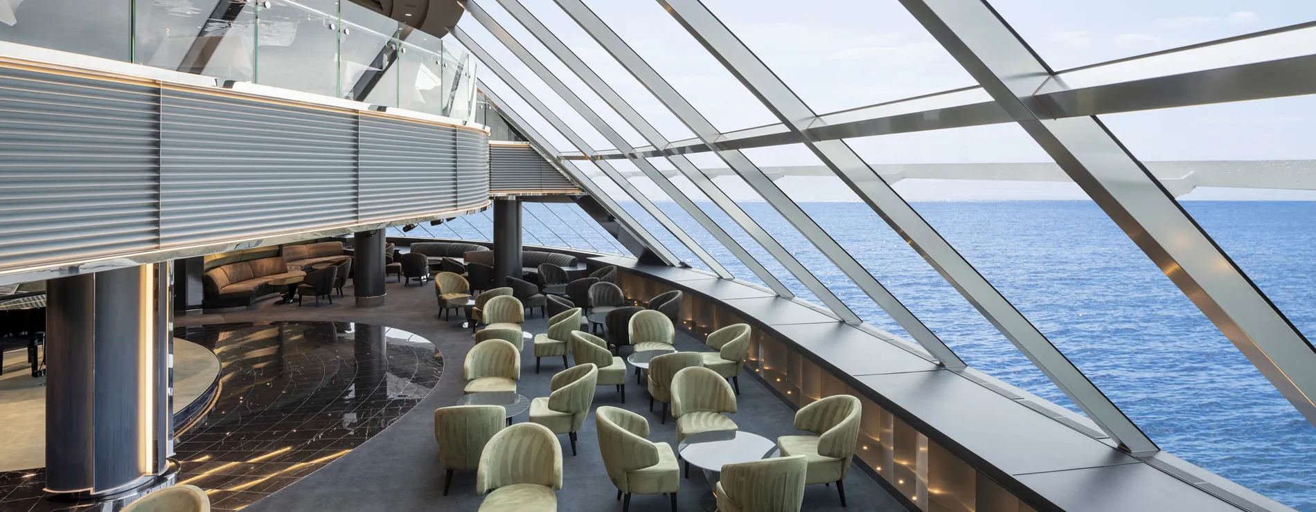 Modern cruise ship lounge with ocean view and glass ceiling