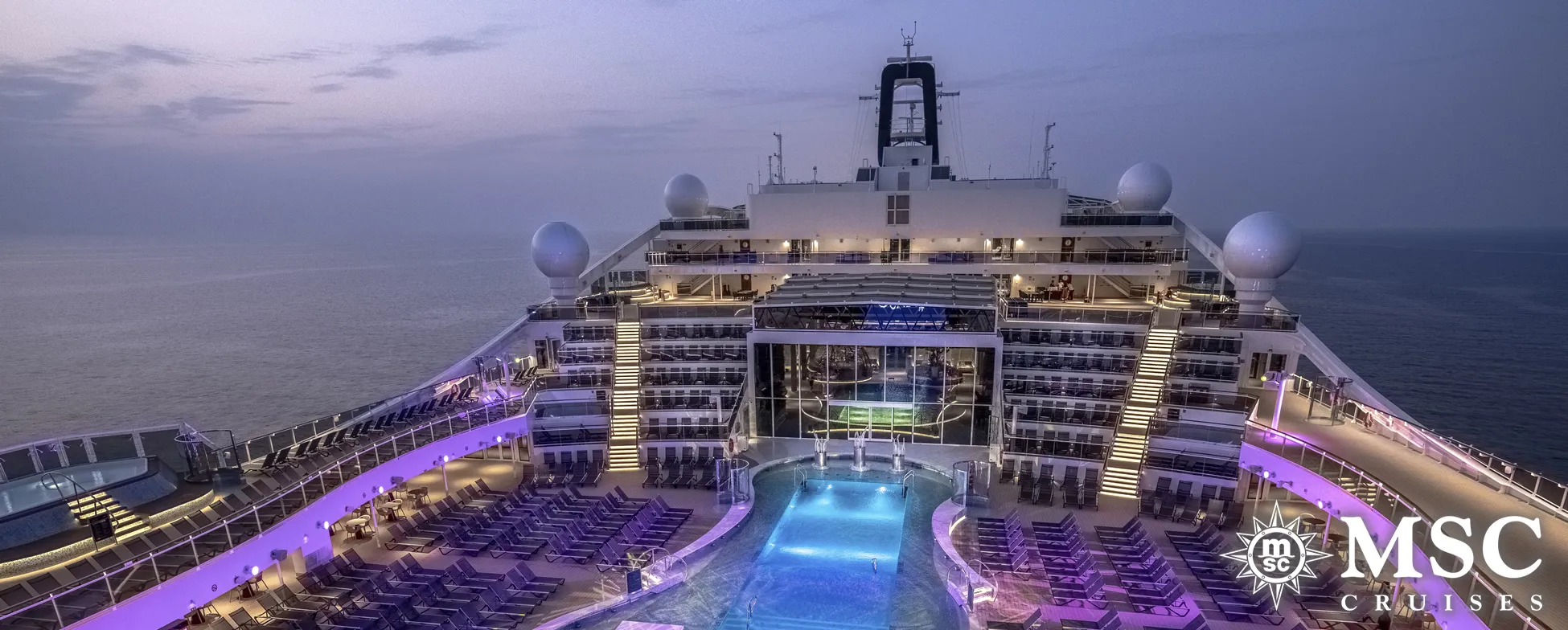 MSC Cruises ship at dusk with illuminated pool deck and purple lighting