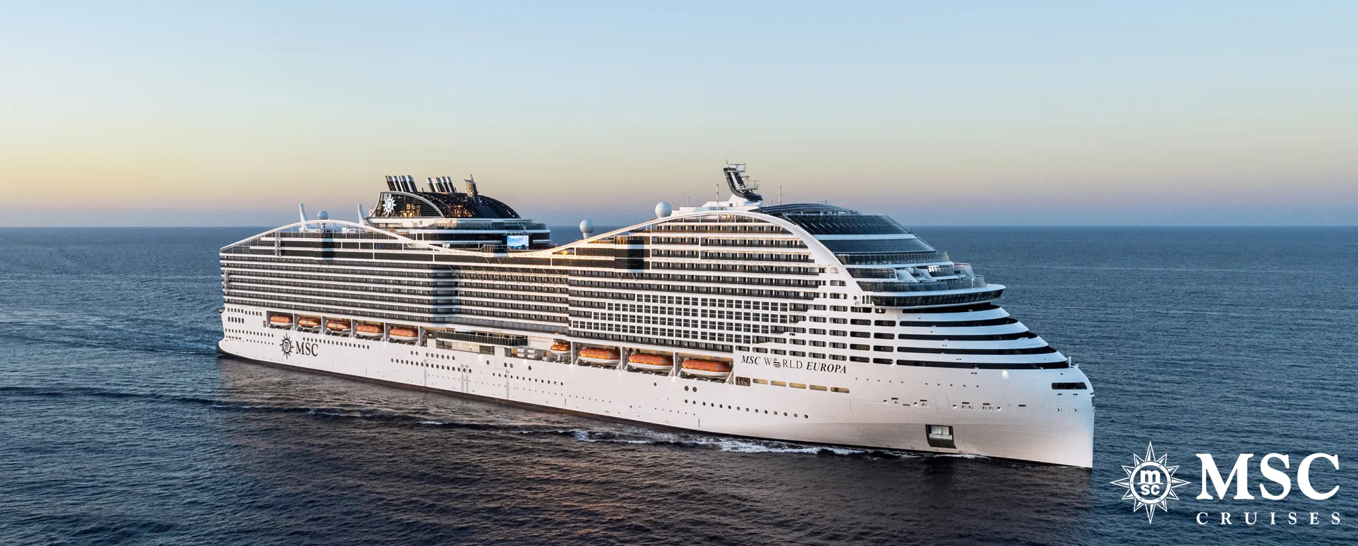 Large white MSC cruise ship sailing on calm blue ocean at sunset