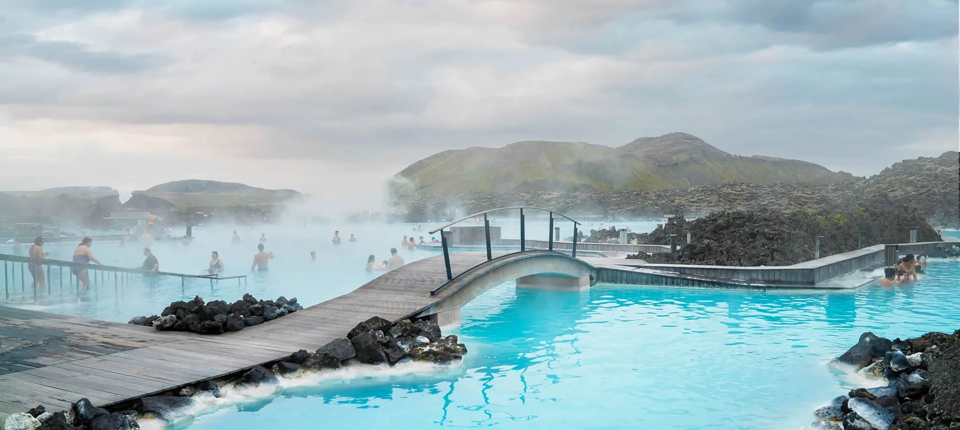 Blue geothermal spa with steamy waters and volcanic landscape in Iceland