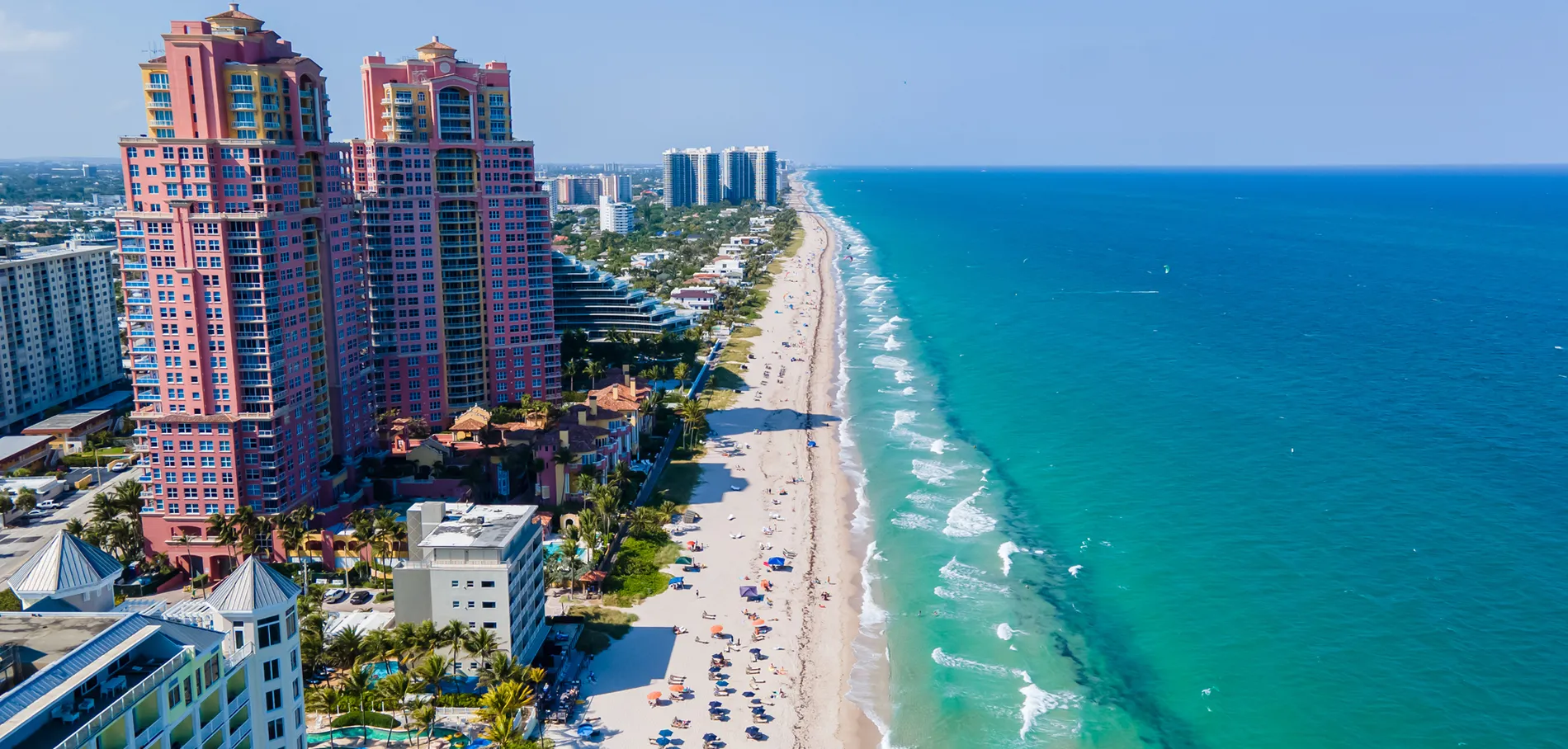 Aerial view of colorful beachfront buildings and turquoise ocean in Florida