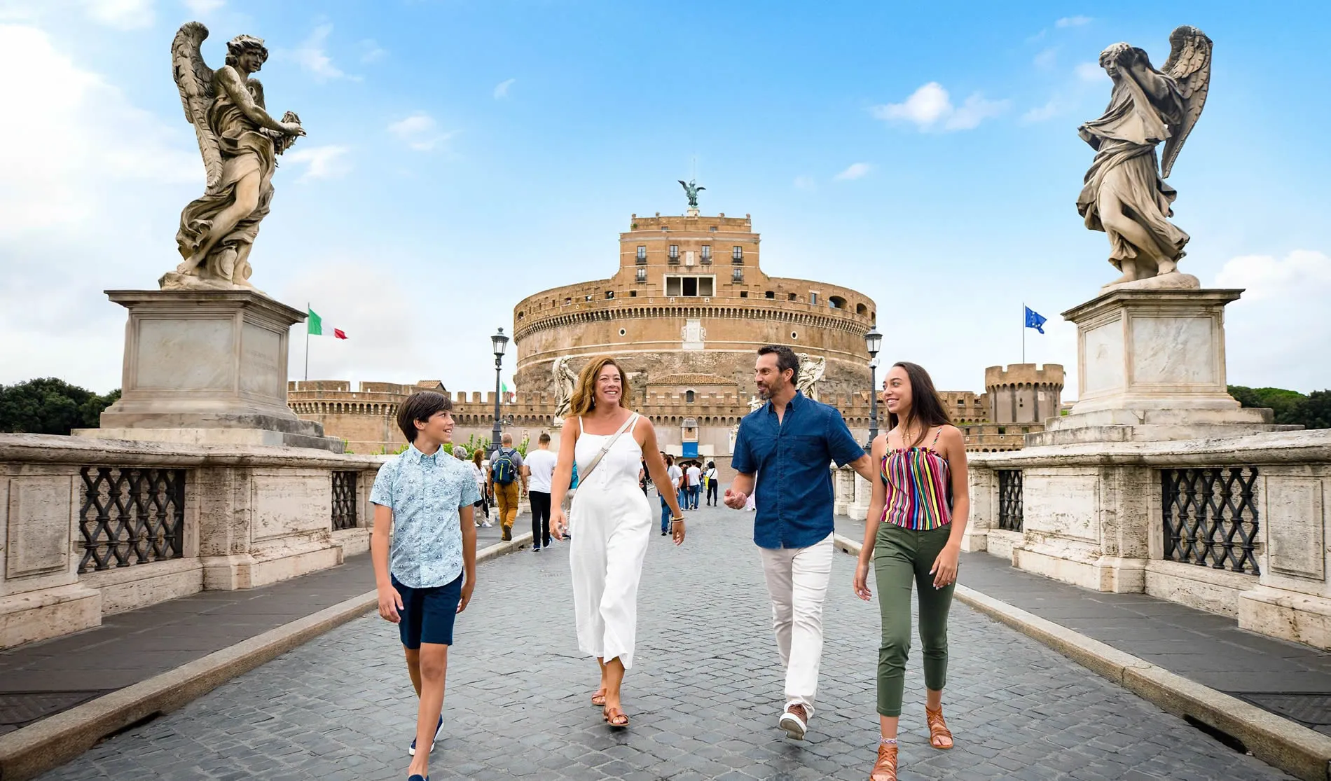 Family walking on bridge near Castel Sant'Angelo in Rome, Italy