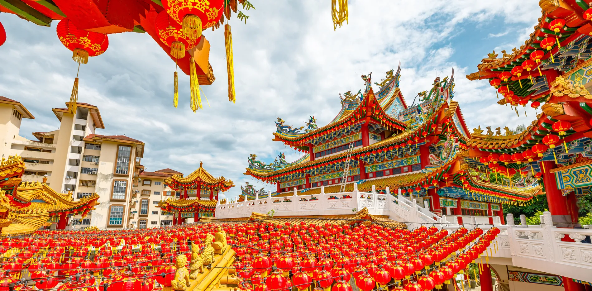 Vibrant red lanterns and ornate Chinese temple during festival celebration