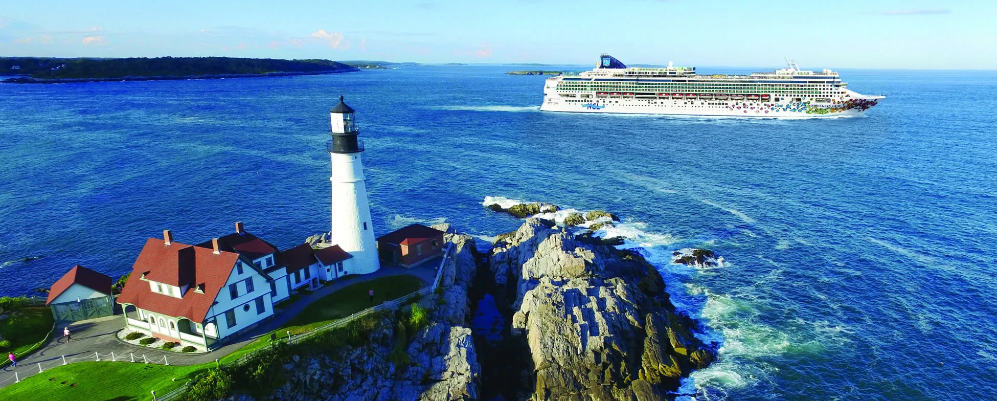 Portland Head Lighthouse with cruise ship in blue ocean, Maine coast