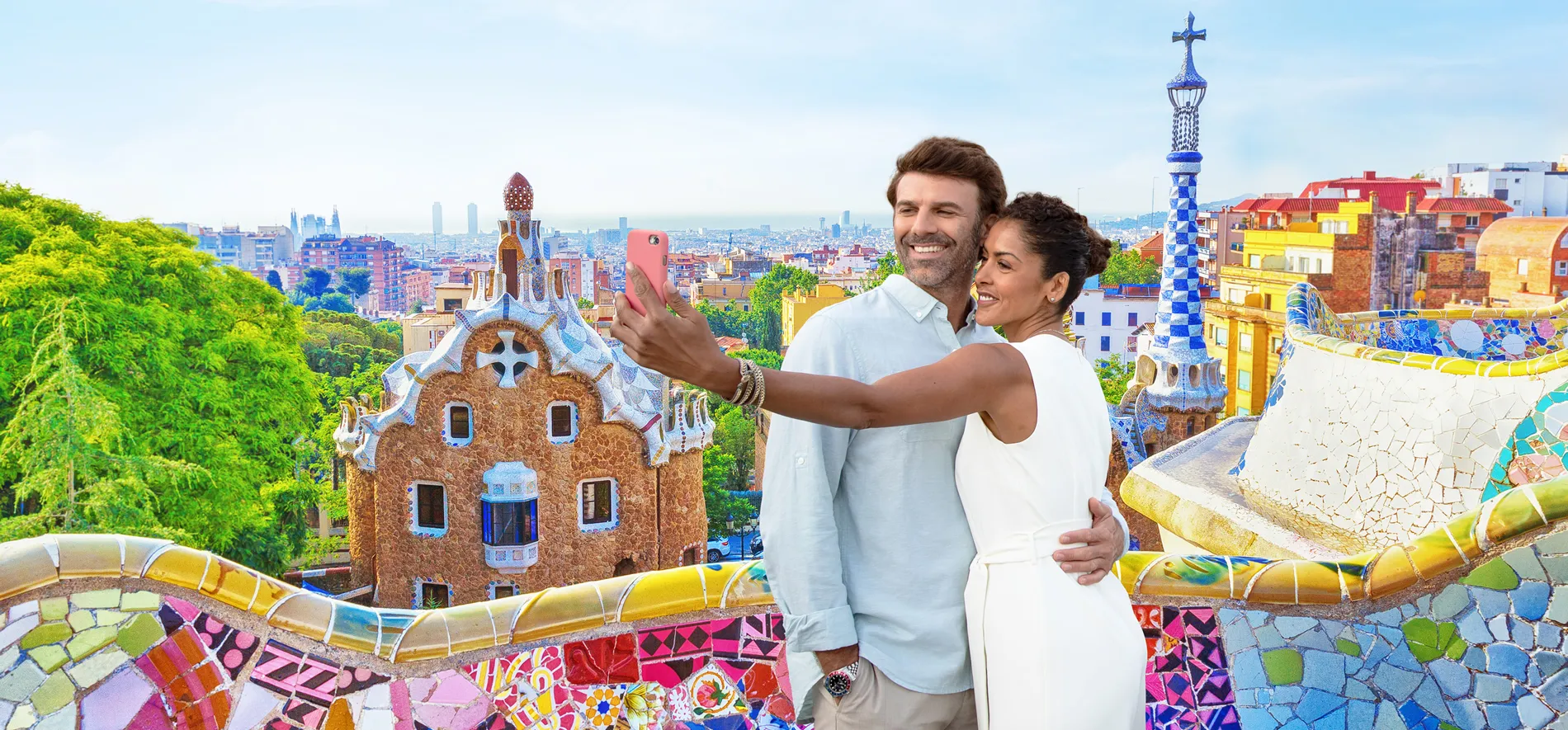 Couple taking selfie at Park Güell with Barcelona's colorful Gaudí architecture