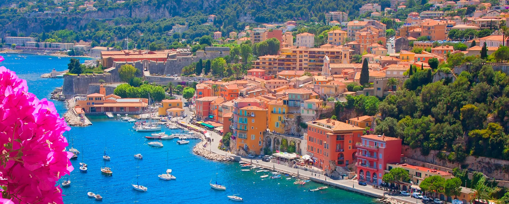 Colorful coastal town with boats, buildings, and vibrant Mediterranean landscape