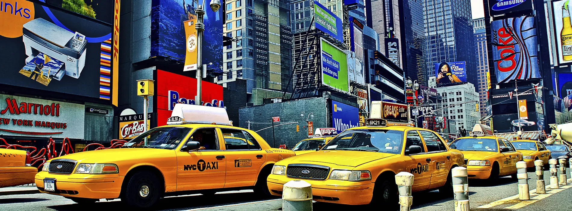 Yellow taxis lined up in bustling Times Square, New York City