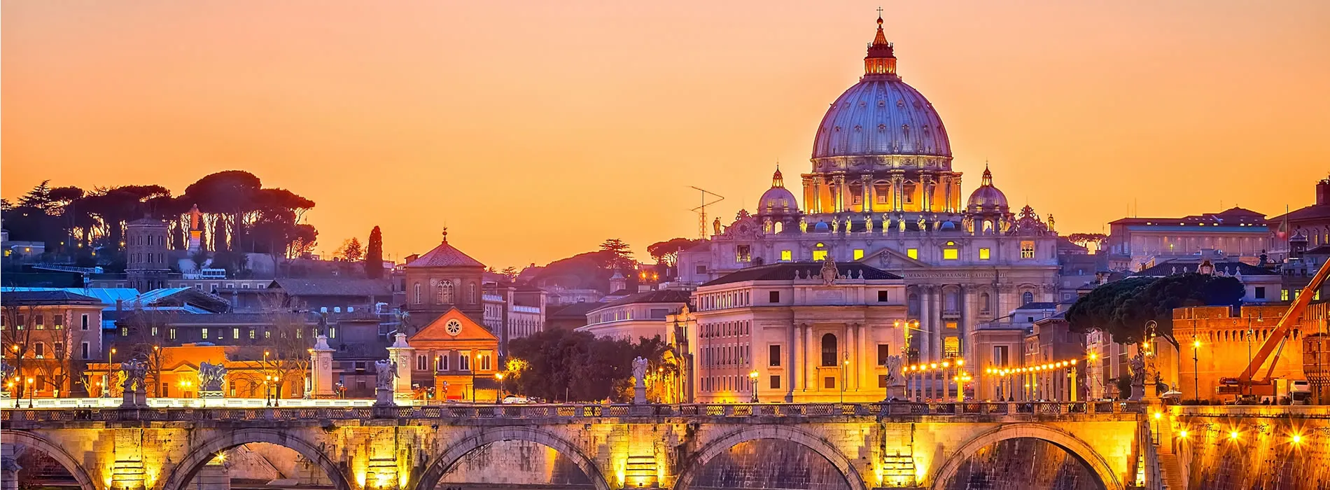 Vatican City at sunset with St. Peter's Basilica and illuminated bridge