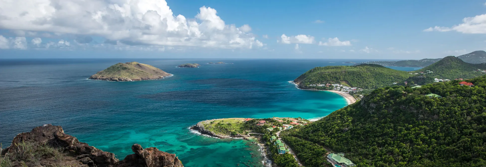 Panoramic view of tropical islands with turquoise waters and lush green landscape