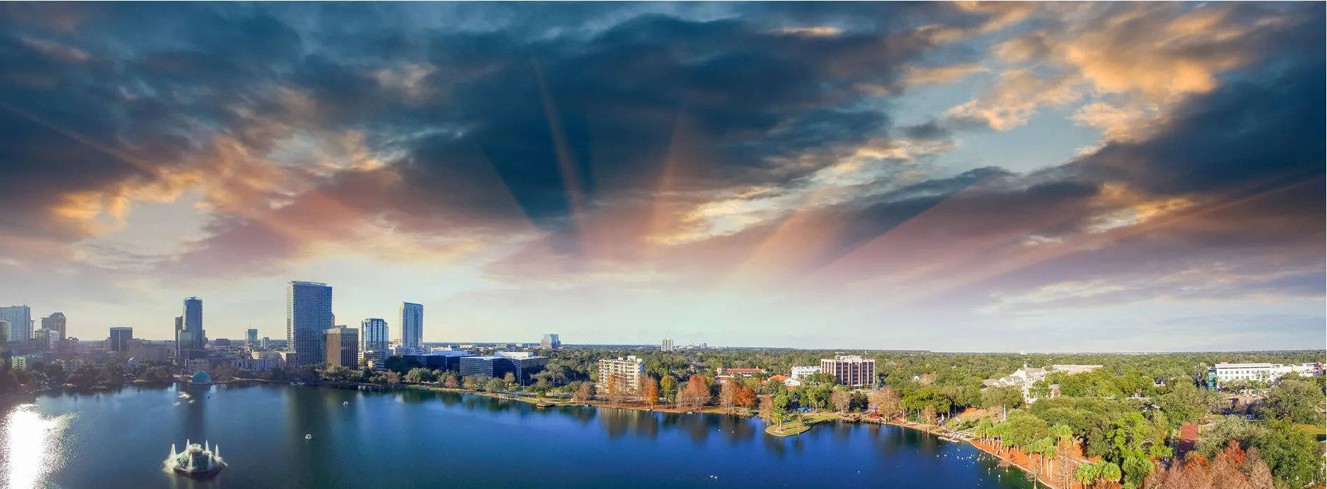 Scenic Orlando skyline with Lake Eola and dramatic sunset clouds