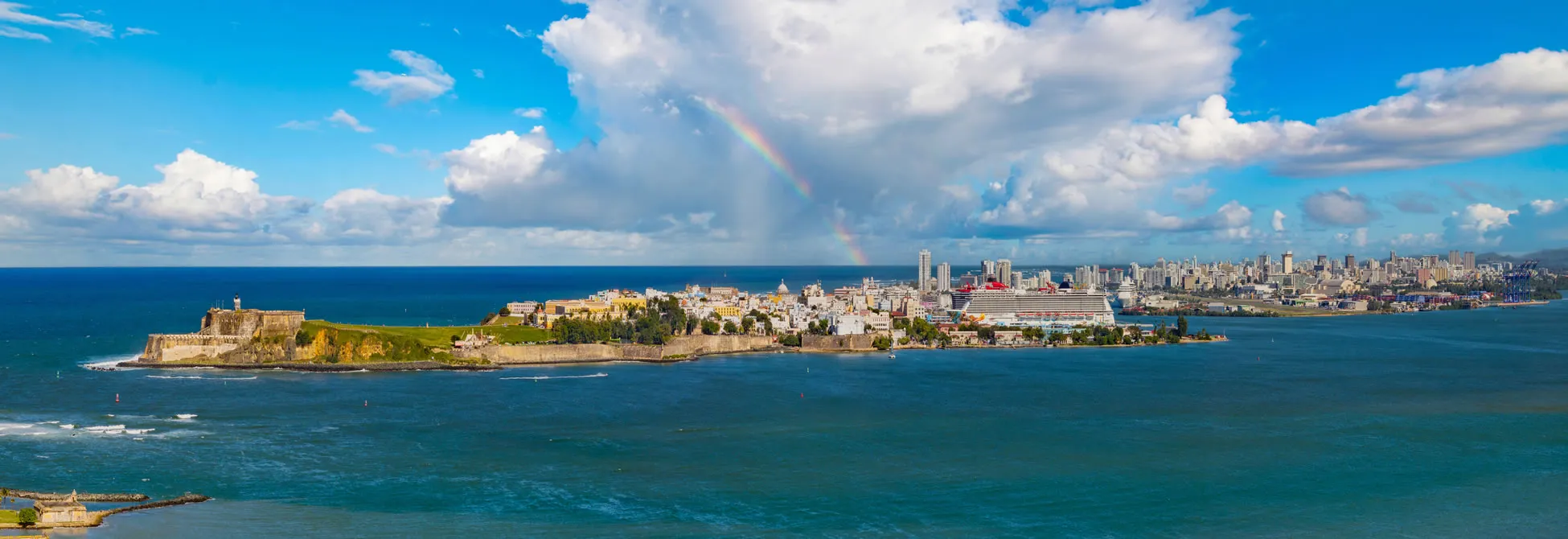 Rainbow over San Juan, Puerto Rico with historic fortress and modern cityscape