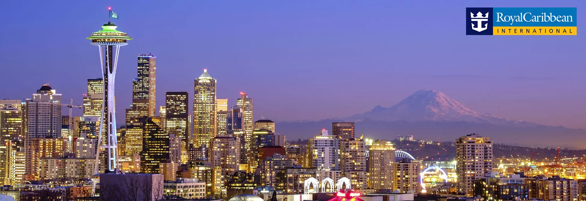 Seattle skyline at night with Space Needle, downtown skyscrapers, and Mount Rainier