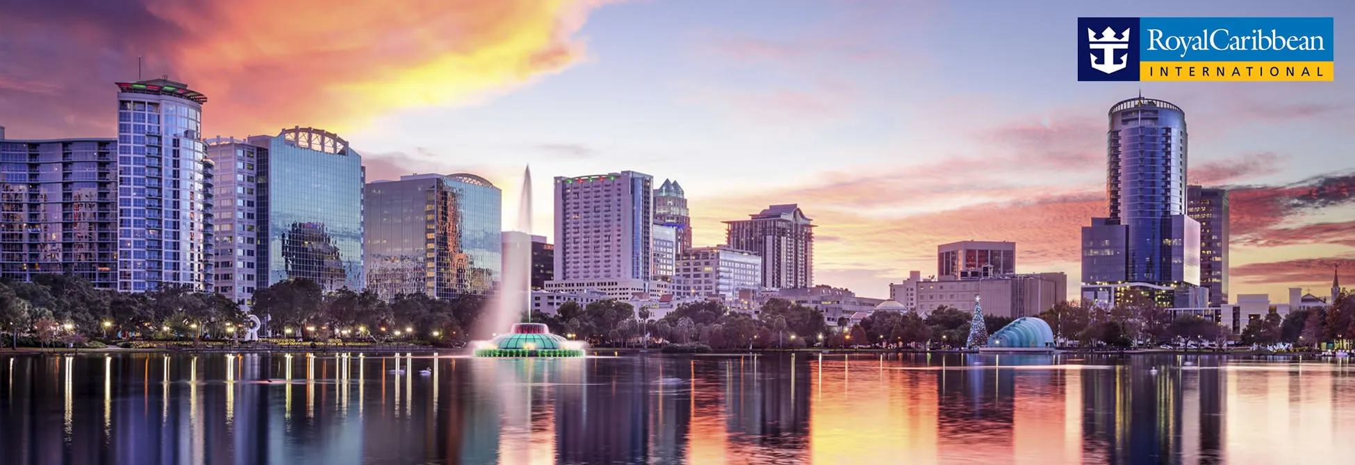 Orlando skyline with Lake Eola fountain at sunset, reflecting on water