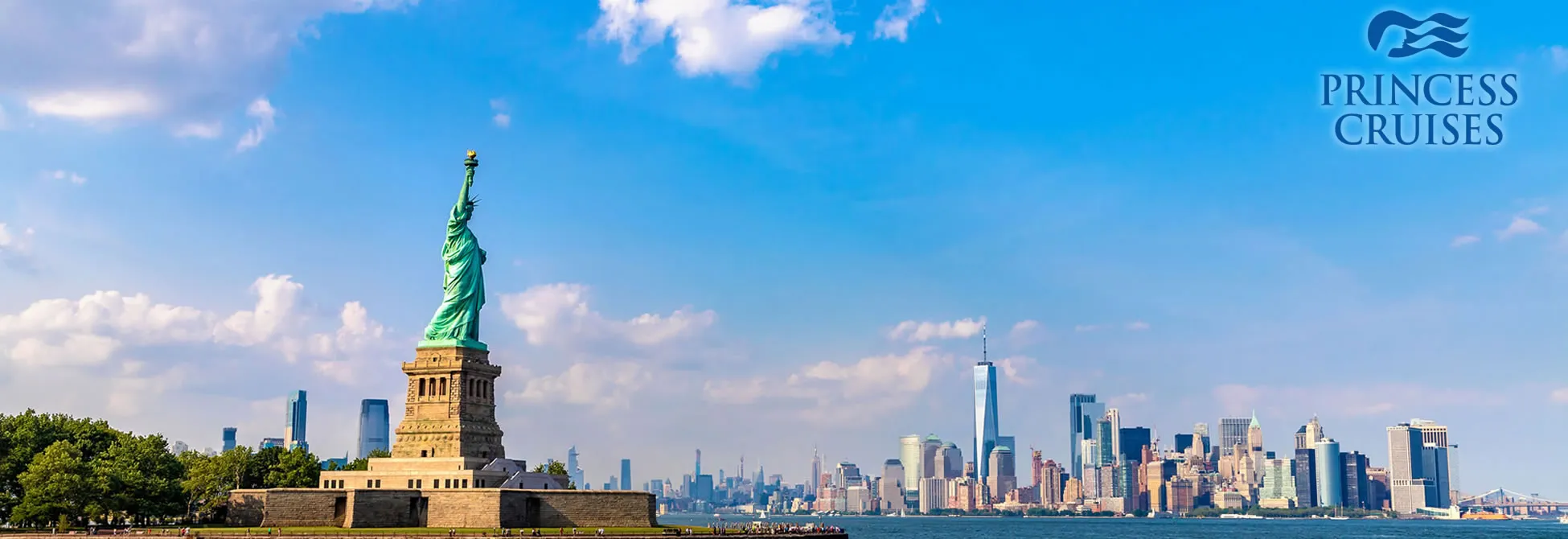Statue of Liberty with New York City skyline on a sunny day
