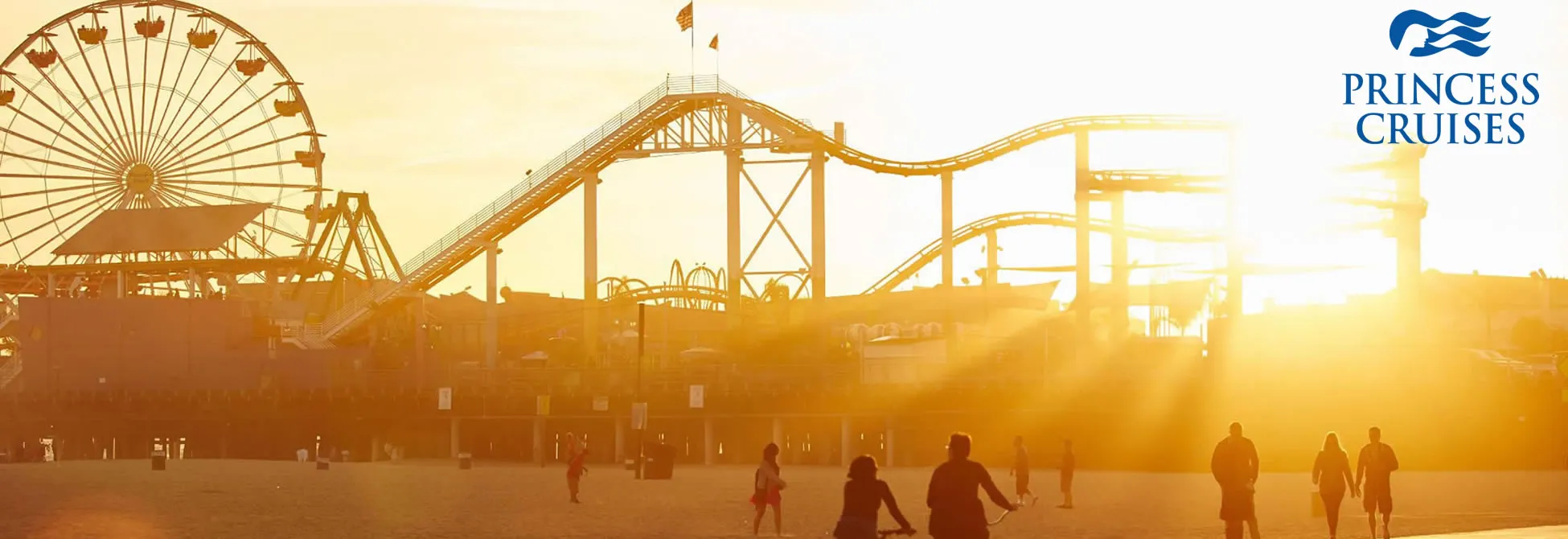 Sunset at boardwalk with Ferris wheel and roller coaster silhouettes