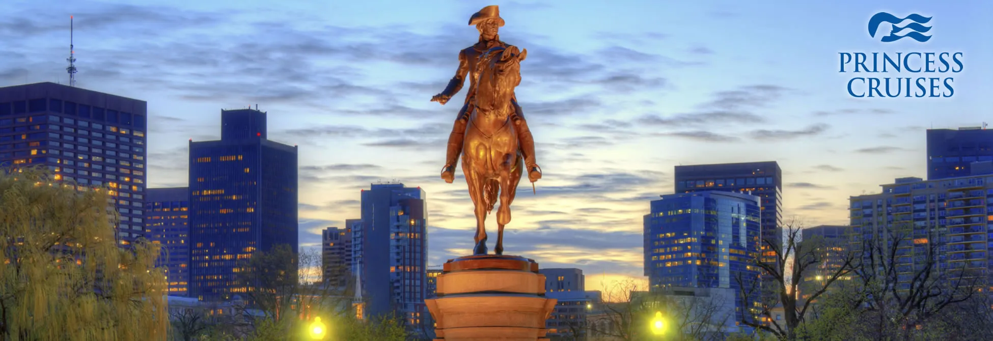 Bronze equestrian statue overlooking city skyline at twilight