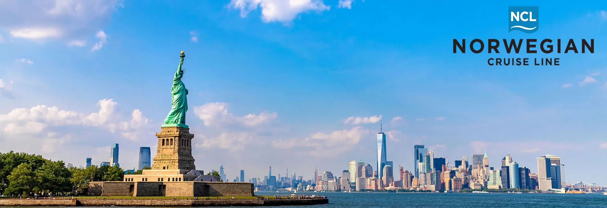 Statue of Liberty with New York City skyline on a sunny day