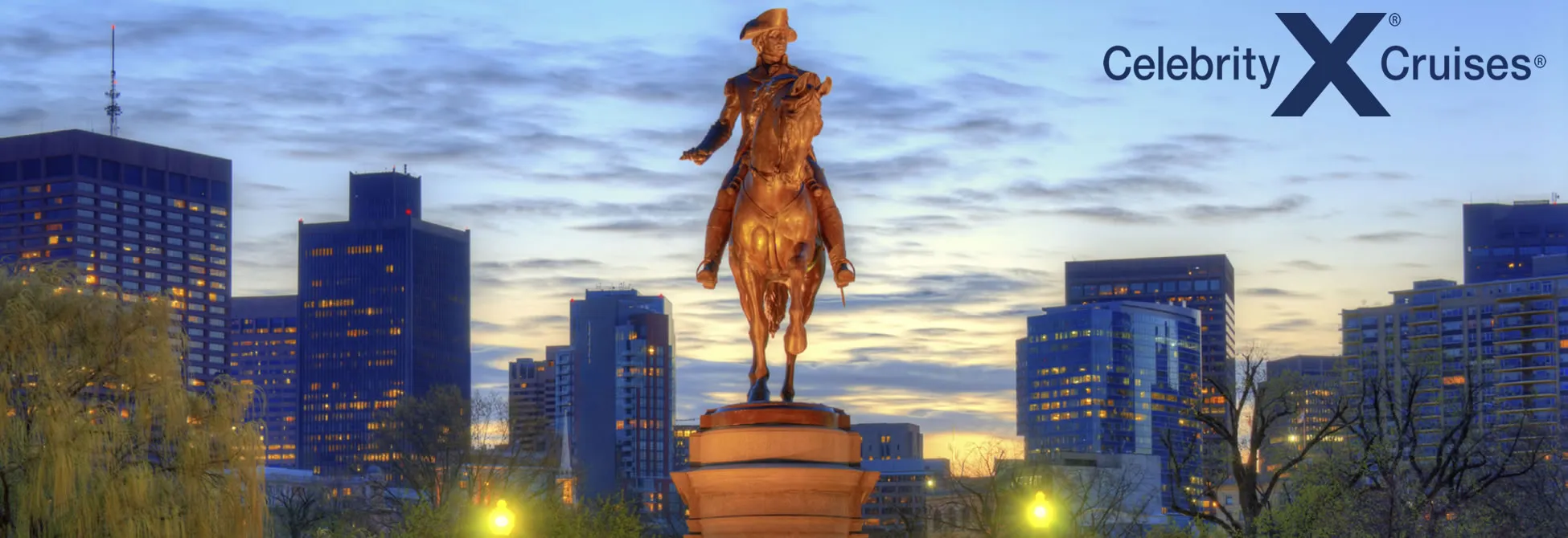 Bronze equestrian statue overlooking city skyline at twilight