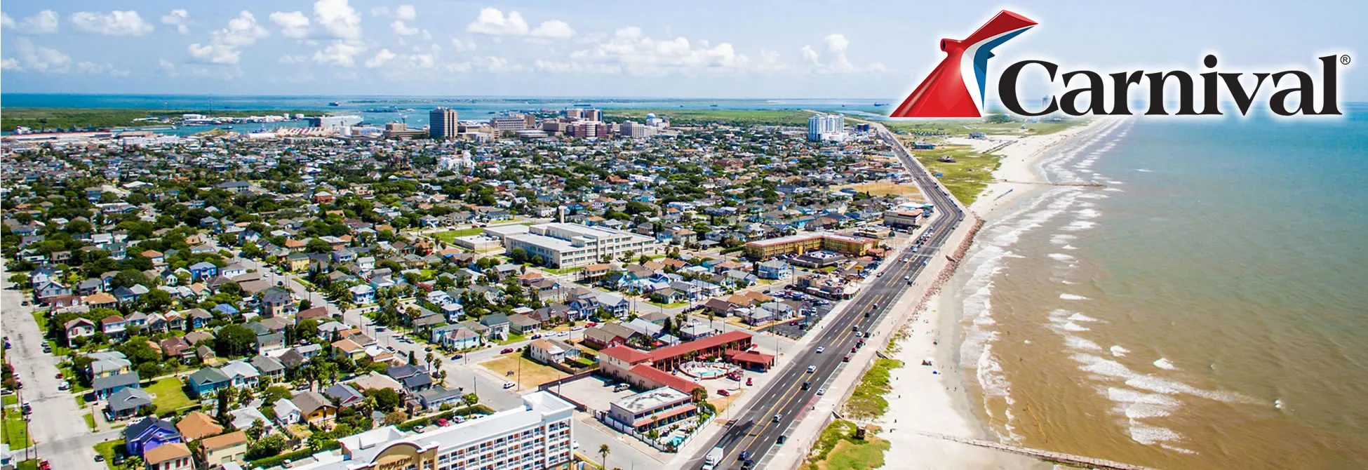 Aerial view of coastal city with Carnival Cruise logo and beach