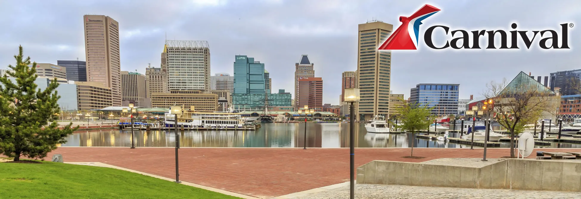 Baltimore Inner Harbor skyline with boats and Carnival Cruise logo